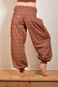 Buy now online, Emma's Emporium floral Genie Harem trousers, lightweight cotton loose fit trousers in unique retro inspired red diamond print. Buy now from Emma's Emporium online store, ethical alternative women's fashion; hippie festival clothing and accessories, ethically sourced from India and South America. Shop online or find us at a festival. All clothing and products available for UK wholesale.