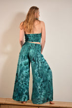 Load image into Gallery viewer, Emma's Emporium tie dye Palazzo trousers, extra wide leg flared hippy trousers with wide elastic waistband in bright vibrant tie dye. Made to ethical fair trade standards for Emma's Emporium slow fashion alternative women's festival clothing.