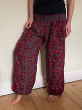 Load image into Gallery viewer, Emma's Emporium fleece genie harem trousers, loose fit warm winter hippy pants, made from machine washable vegan fleece, in bright paisley design. Slow fashion, ethically sourced hippie festival hippy fashion.