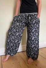 Load image into Gallery viewer, Emma's Emporium fleece genie harem trousers, loose fit warm winter hippy pants, made from machine washable vegan fleece, in bright paisley design. Slow fashion, ethically sourced hippie festival hippy fashion.