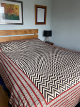 Load image into Gallery viewer, Emma's Emporium king size bedspread with a black chevron pattern on a natural unbleached heavy cotton background, displayed on a bed.
