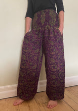 Load image into Gallery viewer, Emma&#39;s Emporium fleece genie harem trousers, loose fit warm winter  hippy pants, made from machine washable vegan fleece, in bright paisley design. Slow fashion, ethically sourced hippie festival hippy fashion.
