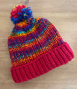 Buy now online from Emma's Emporium, Colourful Nepalese Rainbow Pompom Bobble Hat! Keep your head warm this winter! Pure wool hand knitted hats in vibrant rainbow colours. Made for Emma's Emporium with love by our friends in Kathmandu.