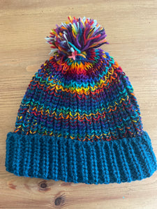 Buy now online from Emma's Emporium, Colourful Nepalese Rainbow Pompom Bobble Hat! Keep your head warm this winter! Pure wool hand knitted hats in vibrant rainbow colours. Made for Emma's Emporium with love by our friends in Kathmandu.