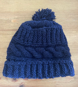Buy now online from Emma's Emporium, Colourful Nepalese cable knit Pompom Bobble Hat! Keep your head warm this winter! Pure wool hand knitted hats in vibrant bold colours. Made for Emma's Emporium with love by our friends in Kathmandu.