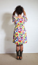 Load image into Gallery viewer, Emma&#39;s Emporium bold floral print summer beach dress, with elastic back and pockets. Colourful lightweight summer beach festival dress!
