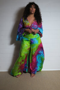 Emma's Emporium tie dye Palazzo trousers, extra wide leg flared hippy trousers with wide elastic waistband in bright vibrant tie dye. Made to ethical fair trade standards for Emma's Emporium slow fashion alternative women's festival clothing.
