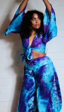 Load image into Gallery viewer, Emma&#39;s Emporium tie dye Palazzo trousers, extra wide leg flared hippy trousers with wide elastic waistband in bright vibrant tie dye. Made to ethical fair trade standards for Emma&#39;s Emporium slow fashion alternative women&#39;s festival clothing.
