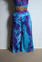 Load image into Gallery viewer, Emma&#39;s Emporium tie dye Palazzo trousers, extra wide leg flared hippy trousers with wide elastic waistband in bright vibrant tie dye. Made to ethical fair trade standards for Emma&#39;s Emporium slow fashion alternative women&#39;s festival clothing.
