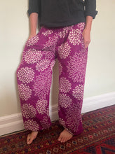 Load image into Gallery viewer, Emma&#39;s Emporium fleece genie harem trousers, loose fit warm winter  hippy pants, made from machine washable vegan fleece, in bright floral magenta design.
