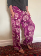 Load image into Gallery viewer, Emma&#39;s Emporium fleece genie harem trousers, loose fit warm winter  hippy pants, made from machine washable vegan fleece, in bright floral magenta design.
