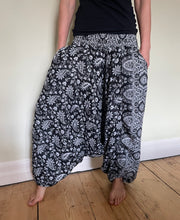 Load image into Gallery viewer, Emma&#39;s Emporium fleece genie harem trousers, loose fit warm winter  hippy pants, made from machine washable vegan fleece, in bright flower or paisley design. Slow fashion, ethically sourced hippie festival hippy fashion.
