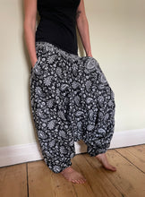 Load image into Gallery viewer, Emma&#39;s Emporium fleece genie harem trousers, loose fit warm winter  hippy pants, made from machine washable vegan fleece, in bright flower or paisley design. Slow fashion, ethically sourced hippie festival hippy fashion.
