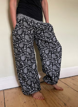 Load image into Gallery viewer, Emma&#39;s Emporium fleece genie harem trousers, loose fit warm winter  hippy pants, made from machine washable vegan fleece, in bright paisley design. Slow fashion, ethically sourced hippie festival hippy fashion.
