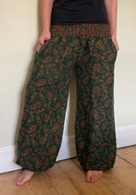 Load image into Gallery viewer, Emma&#39;s Emporium fleece genie harem trousers, loose fit warm winter  hippy pants, made from machine washable vegan fleece, in bright paisley design. Slow fashion, ethically sourced hippie festival hippy fashion.
