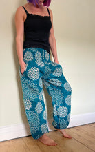 Load image into Gallery viewer, Emma&#39;s Emporium fleece genie harem trousers, loose fit warm winter  hippy pants, made from machine washable vegan fleece, in bright floral magenta design.
