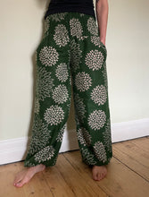 Load image into Gallery viewer, Emma&#39;s Emporium fleece genie harem trousers, loose fit warm winter  hippy pants, made from machine washable vegan fleece, in bright floral magenta design.

