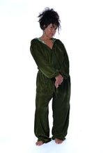 Load image into Gallery viewer, A person wearing a loose, long-sleeve olive green velvet jumpsuit or one-piece with a split neckline and front zipper, standing barefoot against a plain white studio background. Buy now online from Emma's Emporium. Baggy unisex velvet jogger trousers with pockets. Emma's Emporium alternative hippie boho winter women's clothing. Alternative fashion, ethical, slow fashion for men and women.
