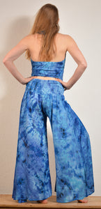 Summer Palazzo pants. Buy online from Emma's Emporium wholesale women's festival, alternative and hippie clothing. Multicoloured rainbow tie dye PALAZZO genie harem loose summer trousers. Shop now at Emma's Emporium UK clothing retail.