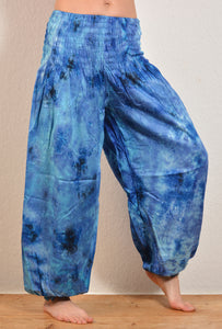 Buy online from Emma's Emporium wholesale women's festival, alternative and hippie clothing. Multicoloured rainbow tie dye genie harem loose summer trousers. Shop now at Emma's Emporium UK clothing retail.