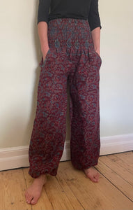 Emma's Emporium fleece genie harem trousers, loose fit warm winter  hippy pants, made from machine washable vegan fleece, in bright paisley design. Slow fashion, ethically sourced hippie festival hippy fashion.
