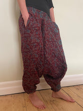 Load image into Gallery viewer, Emma&#39;s Emporium fleece genie harem trousers, loose fit warm winter  hippy pants, made from machine washable vegan fleece, in bright flower or paisley design. Slow fashion, ethically sourced hippie festival hippy fashion.
